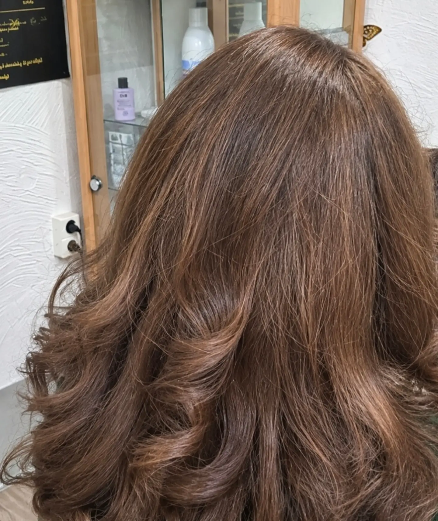 Warmbruin geverfd haar, in krullen geföhnd